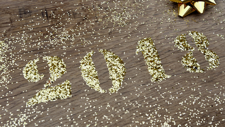 2018 written with glitter on wooden backgroundの写真素材