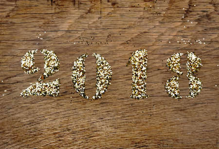 2018 written with glitter on wooden backgroundの写真素材