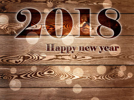 2018 happy new year written on wooden background backgroundの写真素材