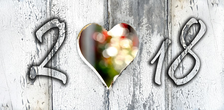 2018 written on a door with heart-shaped hole