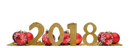 2018 golden figures in front of red christmas balls on white background