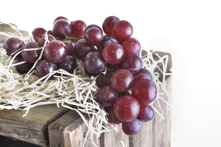 close on a bunch of grapes on a straw put on a crate の写真素材