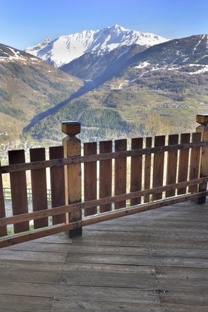 wooden terrace of a cottage with a beautiful panoramic view on mountainの写真素材