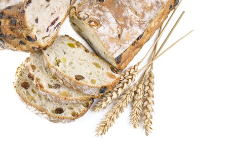close on slices of bread grape and ears of corn on white background