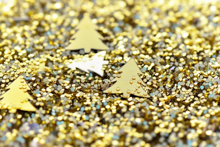 close on golden glitters with fir tree shaped background