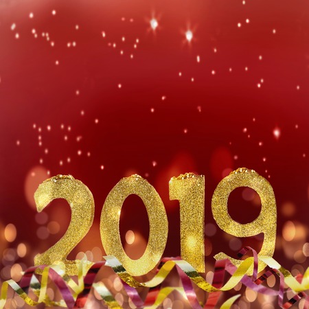 golden sparkly figures 2019 standing on glitters and ribbon on red background