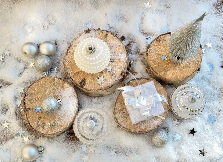 top view on silver christmas decoration and stars in snow backgroundの写真素材