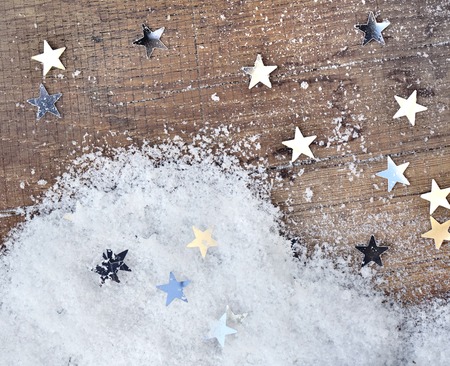 bright stars shape and snow on a plank background