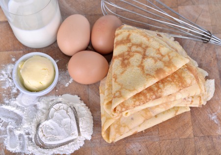 homemade french pancakes with ingredient and heart shaped in the flour on a plankの写真素材