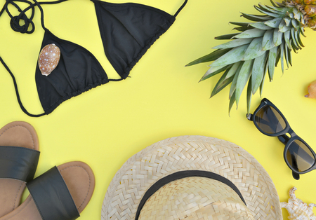 top view on beach accessories on yellow background- summer vacation conceptの写真素材