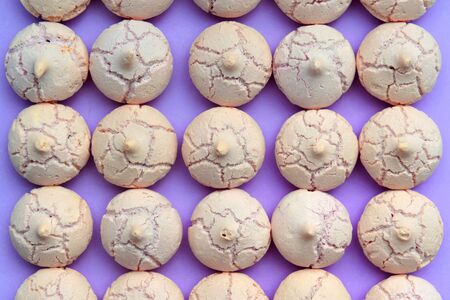 top view on meringues in line on colored backgroundの写真素材