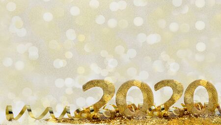 2020 golden figures in glitter and ribbon on abstract blur light background
