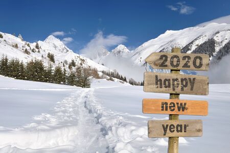 2020 happy new year written on a postsign in the snow on white mountain backgroundの写真素材