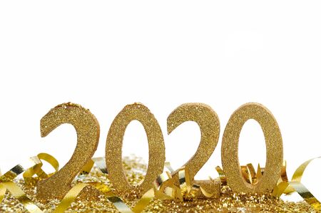 2020 in golden figures standing in ribbon and glitters with santa claus hat on the nine on white...