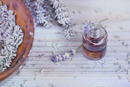 essential oil from lavender  in bottle and dried flowers in bowl の写真素材