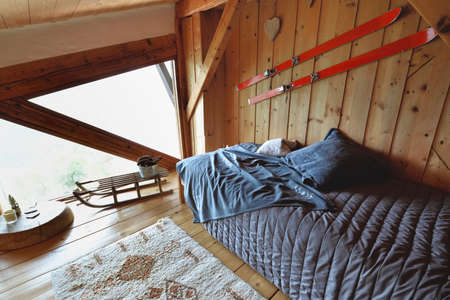 wooden interior of a chalet with old skis and sledge in decorationの写真素材