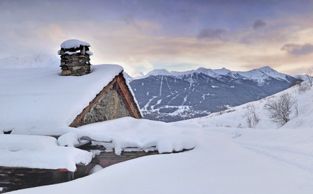 alpine chalet in snow in winter landscape mountainの写真素材
