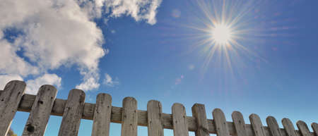 sunlight above wooden fence