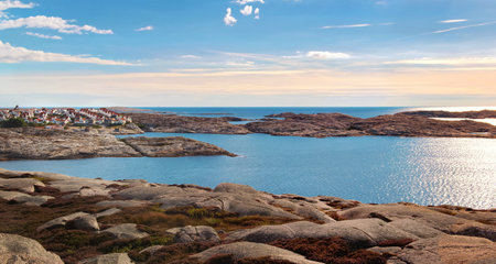 landscape of the coast in baltic sea in island of Smogen in Sweden , coastlie with typical village in back under blue skyの写真素材