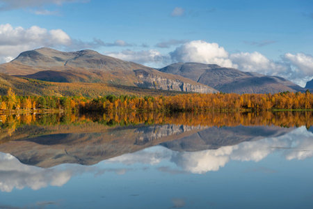 beautiful landscape of Norway mountain and forest reflecting in the waterの写真素材