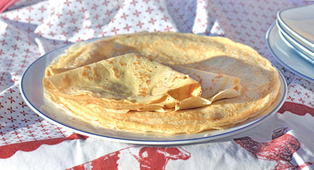 traditional french pancake homemade crepe in a plate on a red and white tableclothの写真素材