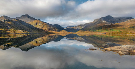 beautiful mountainous landscape reflected on the water with clouds in the sky - svolvaer in Norwayの写真素材