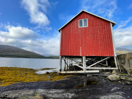 old typical red hut on stilts at the edge on the sea in Sweden scandinaviaの写真素材