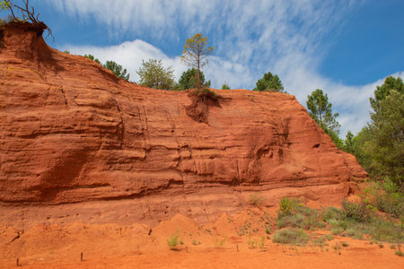 ocher cliff with tree in old quarry ocher colorado provencal in the luberon in franceの写真素材