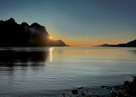 beautiful landscape in a Norway fjord at sunset over the sea with mountain in backの写真素材