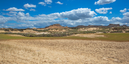 scenic view on Bardenas Reales desert in Spain under sky with white cloudsの写真素材