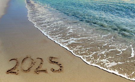 Happy New Year 2015 written in the sand on the seashore
