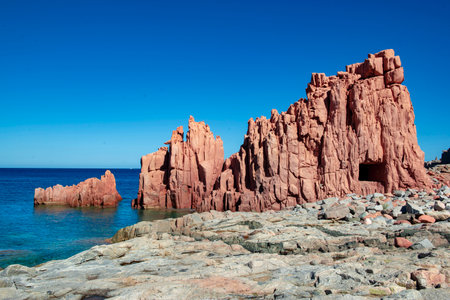 red granite rock on the edge of a crystal sea in Sardinia Italy - Rocce Rosse Arbataxの写真素材