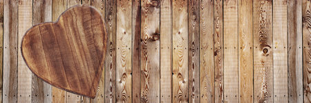 wooden heart-shaped on wooden background with rustic planks and empty spaceの写真素材