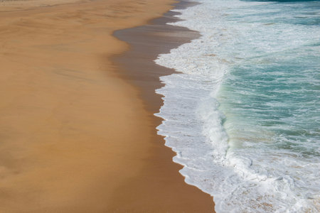 foam of the sea on the sand of a beach on the west coast of Portugal.view high on the waves...