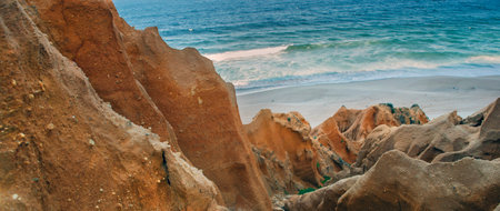 beautiful beach in the Atlantic Ocean bordered by hard sand cliffs forming a canyon Medides beach in Portugalの写真素材