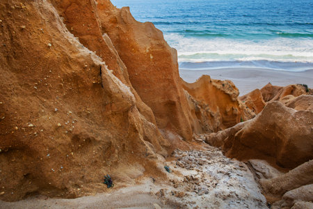 beautiful beach in the Atlantic Ocean bordered by hard sand cliffs forming a canyon Medides beach in...