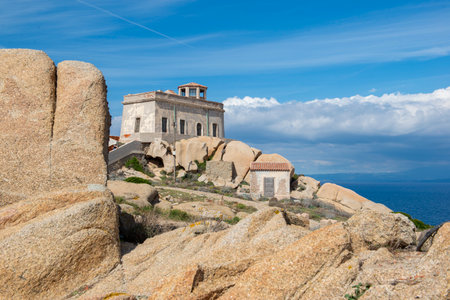 view on lighthouse capo testa in Sardinia in cliffs at the edge of the sea - Santa Theresa Galluraの写真素材