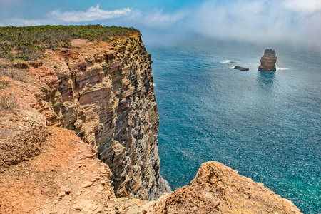 view of the cliffs at edge of the sea in coast in Portugal in the Algarve at Ajezurの写真素材
