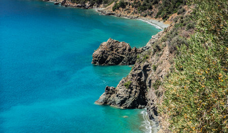 view on the peloponnese coast with beautiful blue water at the foot of the cliffs in Greeceの写真素材
