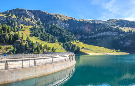 vaulted dam of Saint GuÃ©rien in the turquoise blue water of the Beaufortain massif at French Alpsの写真素材