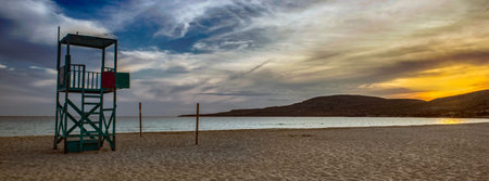 lifeguard high chair on the beach Simos on the island of Elafonisos with sunset in peloponnese ,...