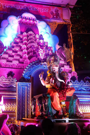 Idol of Indian God Ganesh beautifully decorated with flowers and lights being taken for Emerson in water at pune Maharasthra India on 12 September 2019のeditorial素材