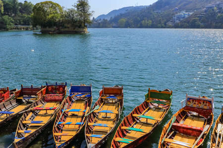 Boats at the banks of a lake at Bheemtal, a hill station in uttrakhand India with mountains and trees in the background clicked on 22 March 2016のeditorial素材