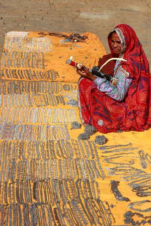 An Indian street vendor women selling ethnic junk jewelry in Jaiselmer, Rajasthan, India on 19 February 2018のeditorial素材