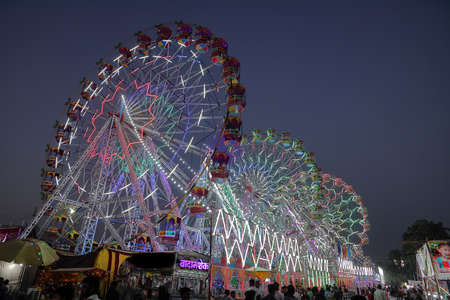 High dynamic range Selective focus image of Giant wheels at Pushkar Camel fair at Rajasthan, India on 20 October 2017のeditorial素材