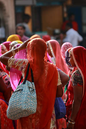 A Selective focus image of a group of Indian women wearing traditional clothes with vibrant colors at Pushkar, Rajasthan, India on 19 November 2018のeditorial素材