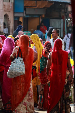 A Selective focus image of a group of Indian women wearing traditional clothes with vibrant colors at Pushkar, Rajasthan, India on 19 November 2018のeditorial素材