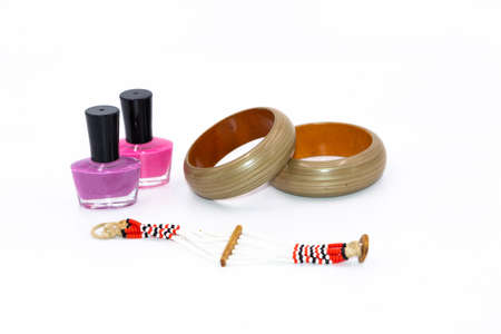 Selective focus Narrow depth of field Macro image of three bottles of colored nail polish and a brace-late  with white backgroundの写真素材