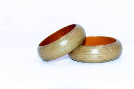 A Selective focus Macro image of a pair of green wooden bangles captured from various angles with clean white backgroundの写真素材