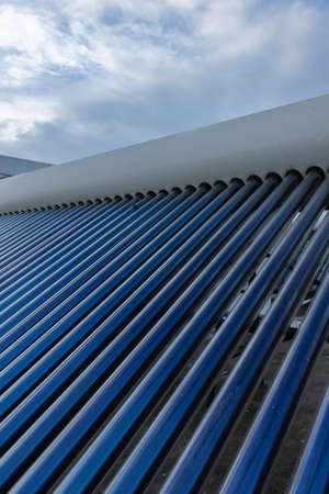 solar panels and tubes installed on roof top of houses and buildings to conserve energy